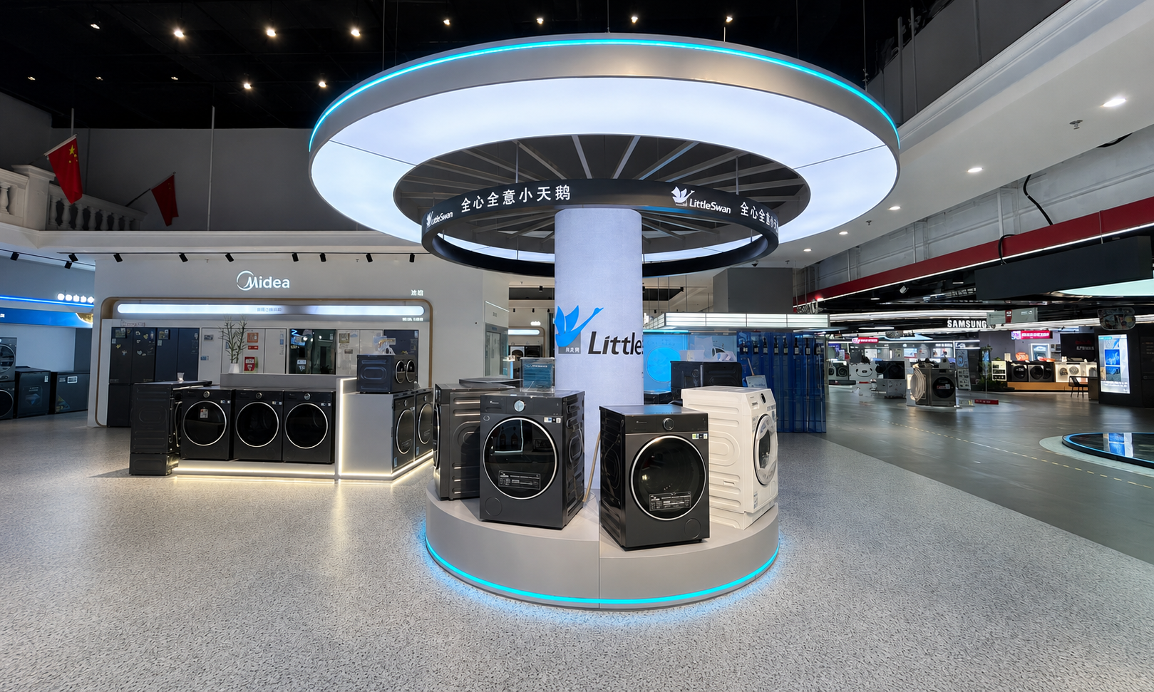 Wide showroom view of Little Swan circular washer display platform with four appliances, central branded column, dual illuminated rings and blue base lighting