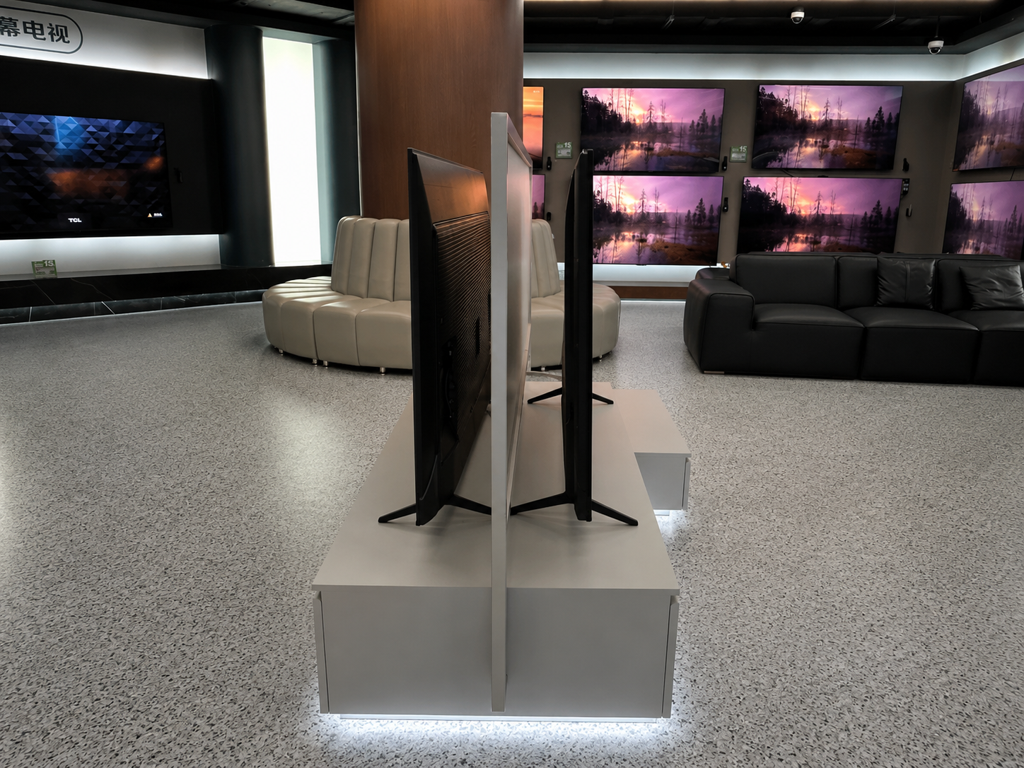 Narrow side view of TCL double-sided television display showing the central frame, back-to-back screens and shared cabinet base